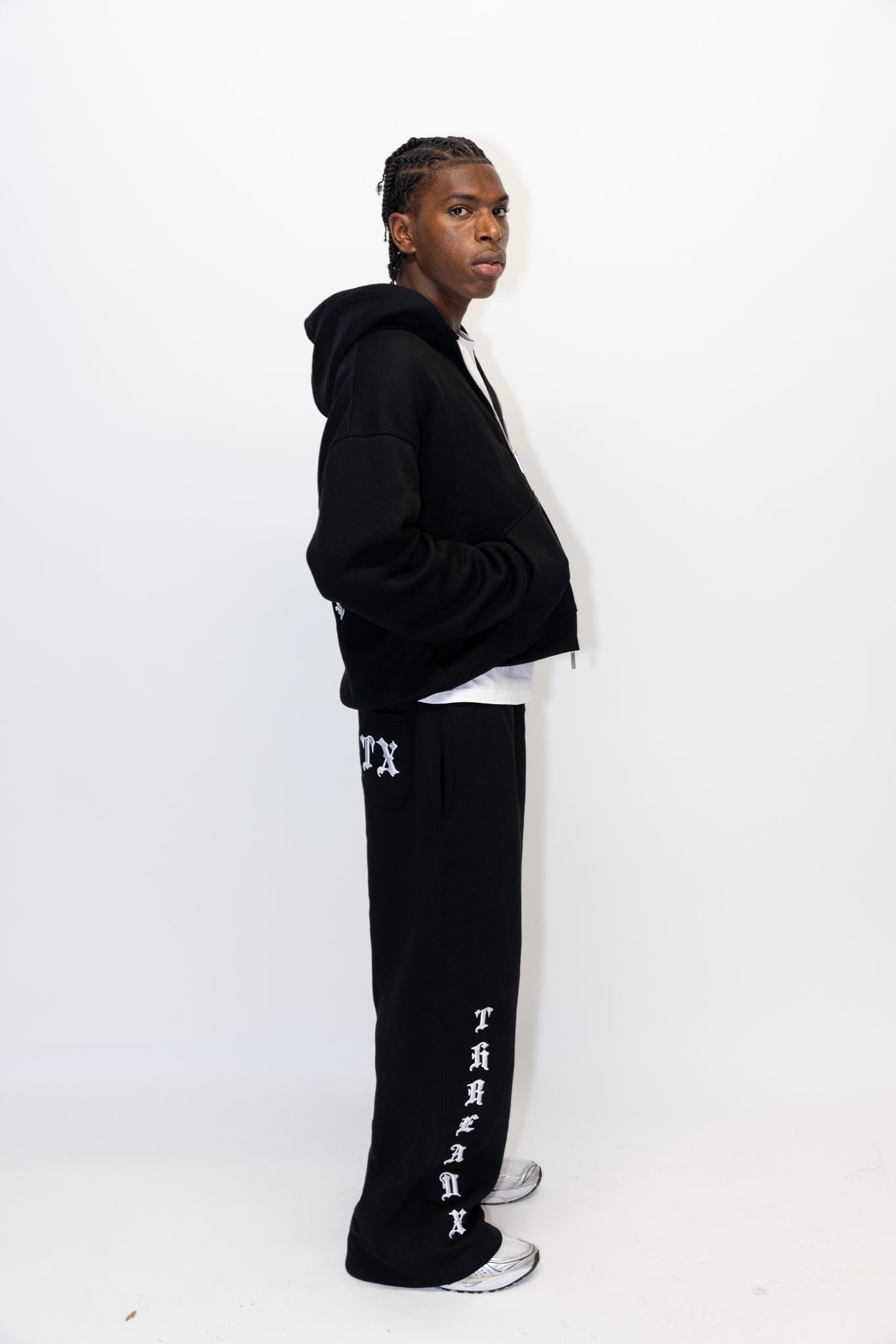 Men's black straight-leg track pants with embroidered Thread X logo and hidden laces.