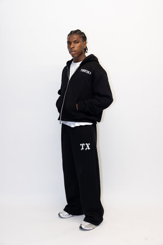 Men's black straight-leg track pants with embroidered Thread X logo and hidden laces.